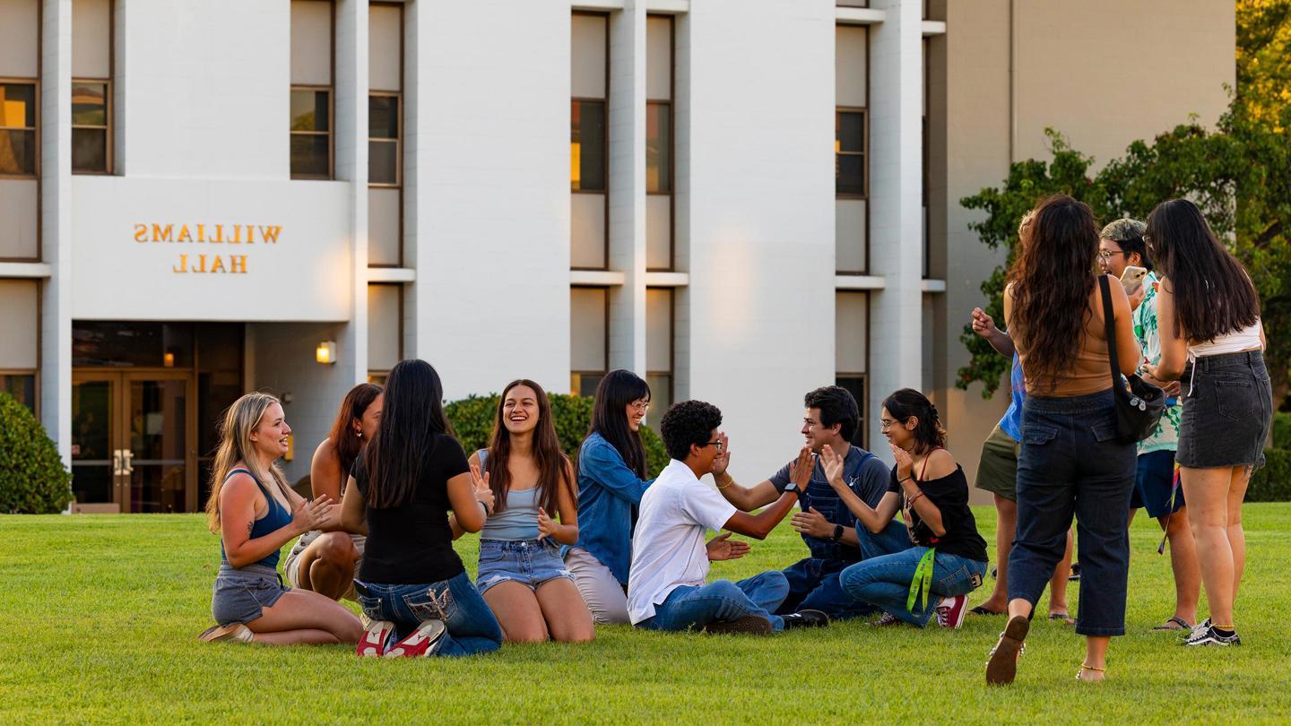 Media masthead - First-year students on grass